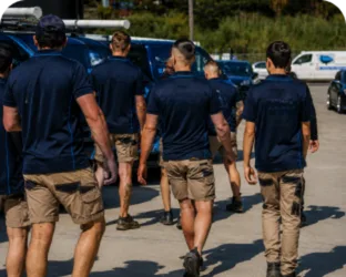 Plumbers walking to their service vans on a North Sydney job