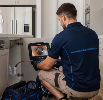 Clearing a blocked sink at a North Sydney property